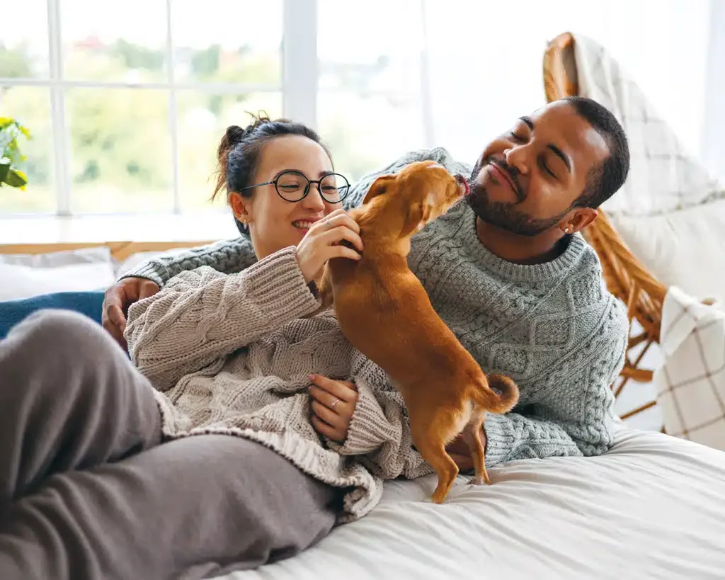 young couple at home with their dog