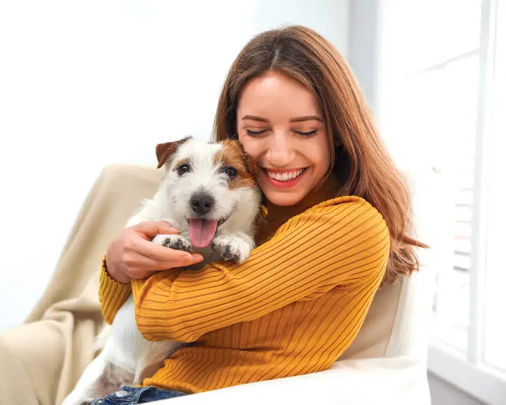 happy woman holding her dog